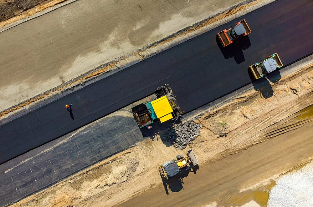 aerial view of workers paving a road