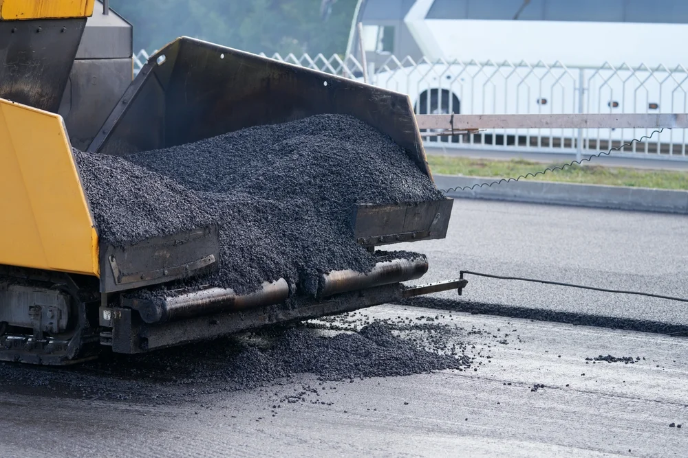 fresh asphalt mix in the back of paving truck